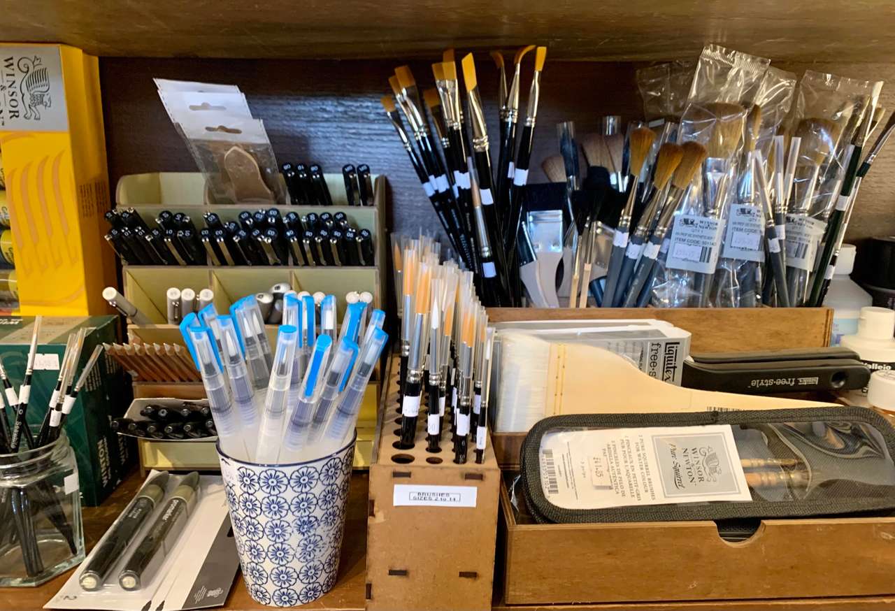 Art room shelves: pots and racks of artists’ brushes, water brushes and pens