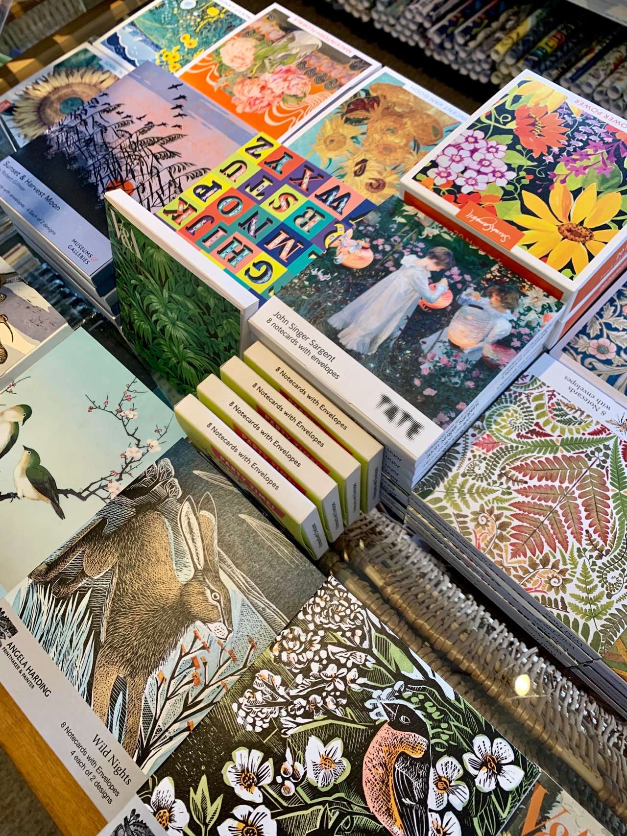 Boxes of illustrated notecards laid out on a table