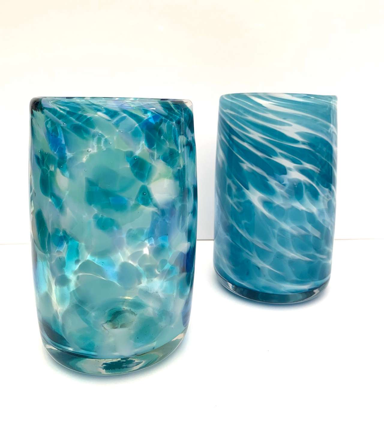 Two hand-blown glass vases in mottled and swirled blues and whites